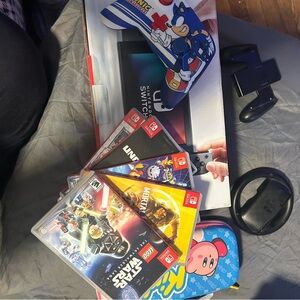 Nintendo Switch with gray Dock, Blue Kirby Case and Sonic Controller Accents,